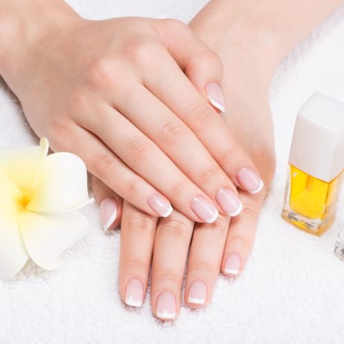 woman-nail-salon-receiving-manicure-by-beautician-beauty-treatment-concept (1)